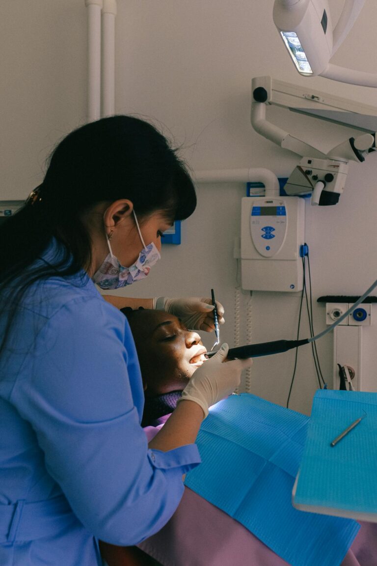 A dentist performs a dental check-up on a woman in a modern clinic, emphasizing healthcare and professionalism.